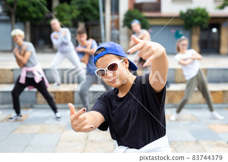 Modern teen girl krump dancer performing with group 83744379