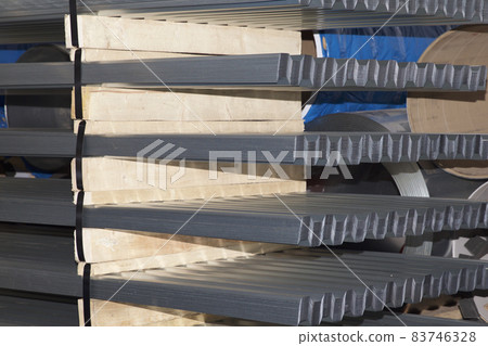 Profiled galvanized sheet in packs at the metal products warehouse 83746328