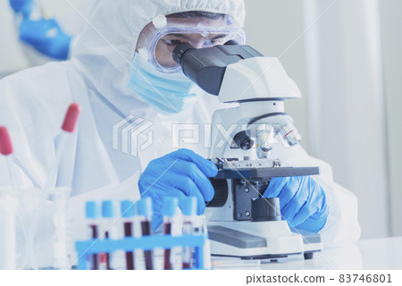 Male Scientist look into Microscope research in science laboratory. Asian scientist looking equipment laboratory chemistry labs. Covid-19 coronavirus biochemistry research experiment vaccine concept Male Scientist look into Microscope research in science laboratory. Asian scientist looking equipment laboratory chemistry labs. Covid-19 coronavirus biochemistry research experiment vaccine concept 83746801