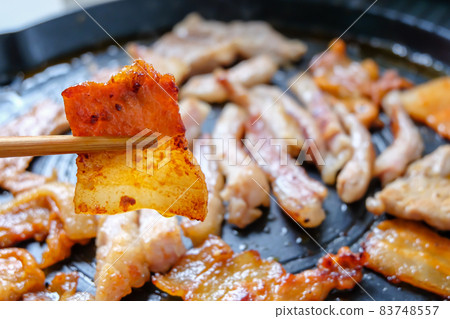 Korean traditional grilled BBQ food, samgyupsal, pork with gochujang and Grilled Pork Neck on hot pan, Food for camping in winter. 83748557