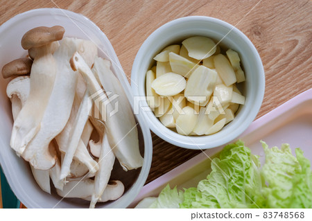Lettuce, Eryngii Mushroom, cucumber, and garlic, side dishes of Korean Barbecue, Korean traditional grilled BBQ food. 83748568