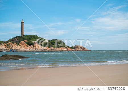 Scenic view of the lighthouse on the beautiful shore with large stones. The beauty of nature. Amazing places in the world. bay with crystal water 83749028