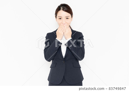 Business woman posing to hide her mouth Business woman posing to hide her mouth 83749847