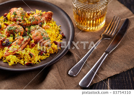 Chicken biryani. Prepared in a wok. Natural wood in the background. Top view. 83754310