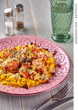 Chicken biryani. Prepared in a wok. Natural wood in the background. Top view. 83754315