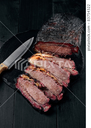 Fresh Brisket BBQ beef sliced for serving against a dark background 83754322