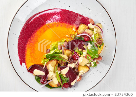 Healthy diet: colorful beetroot salad with potatoes and shredded leaves. Close up Healthy diet: colorful beetroot salad with potatoes and shredded leaves. Close up 83754360