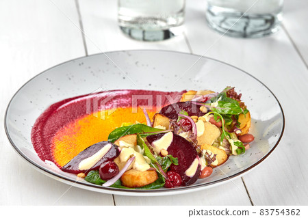 Healthy diet: colorful beetroot salad with potatoes and shredded leaves. Close up Healthy diet: colorful beetroot salad with potatoes and shredded leaves. Close up 83754362
