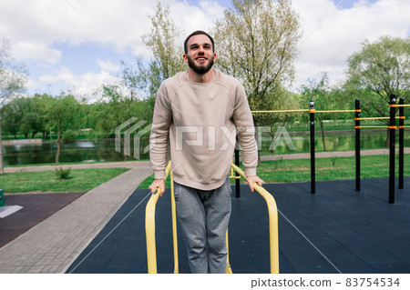 Caucasian sportsman on crossbar during street workout. Healthy lifestyle and street sport concept Caucasian sportsman on crossbar during street workout. Healthy lifestyle and street sport concept 83754534