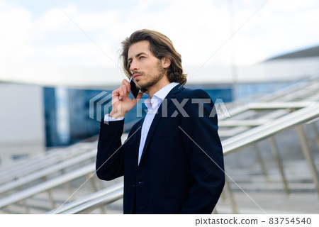 Portrait of an handsome businessman in the city. 83754540