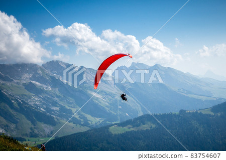 paragliding flight in the mountains. Le Grand-Bornand, France 83754607