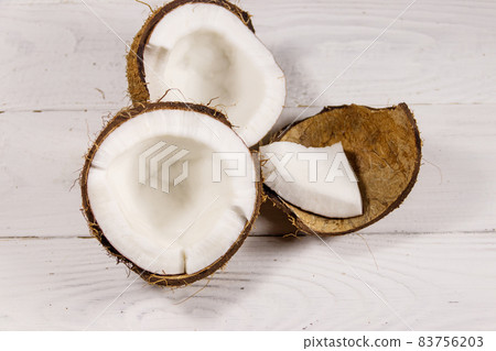 Fresh ripe coconut on white wooden table 83756203