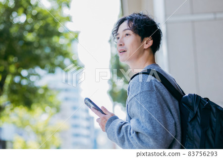 A man carrying a backpack 83756293