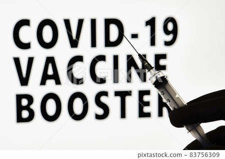 Covid-19 Vaccine booster dose. Hand of the doctor holds a syringe with new Covid vaccine booster dose 83756309