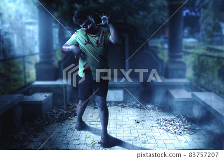 Scary zombie with blood and wound on his body walking Scary zombie with blood and wound on his body walking 83757207