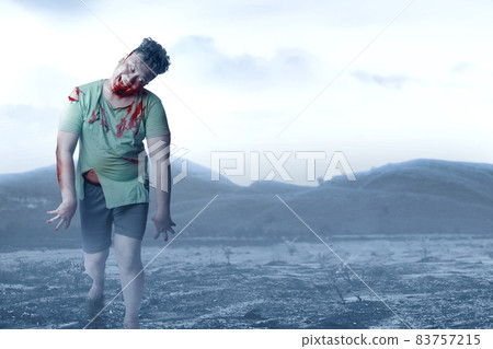 Scary zombie with blood and wound on his body walking Scary zombie with blood and wound on his body walking 83757215