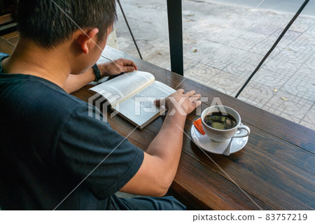 Student reading book and drinking coffee 83757219