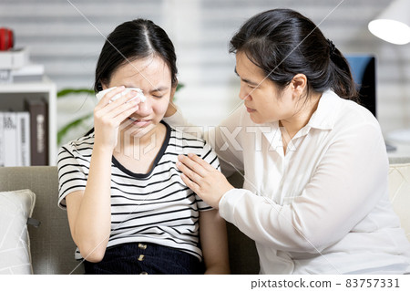 Stressed asian teenager girl crying,life problems with friends at school,disappointed by the love relationships breakup with boyfriend,mother embracing comforting and counselling a sad teenage student Stressed asian teenager girl crying,life problems with friends at school,disappointed by the love relationships breakup with boyfriend,mother embracing comforting and counselling a sad teenage student 83757331