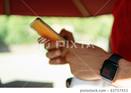 the man looks at the phone the man looks at the phone 83757453