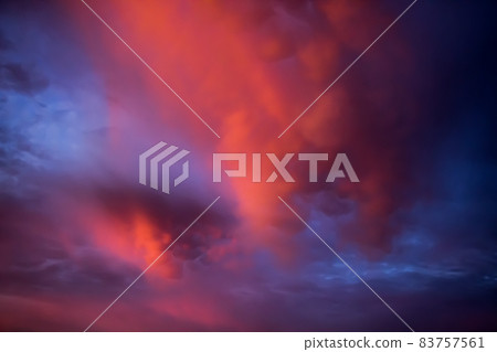 Unusual pink-purple mammatus clouds at sunset. Blurred image for backgrounds. 83757561