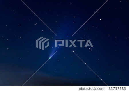 Neowise comet in the starry sky. Astrophotography - a view of a bright meteor C/2020 F3. Selective focus, grain image Neowise comet in the starry sky. Astrophotography - a view of a bright meteor C/2020 F3. Selective focus, grain image 83757583