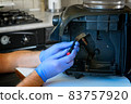 A repairman repairs a broken coffee maker 83757920