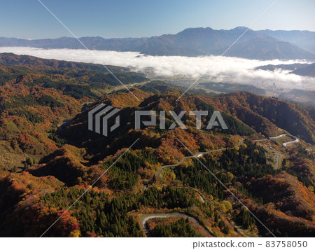 Autumn leaves and sea of clouds aerial view of Uonuma skyline 83758050