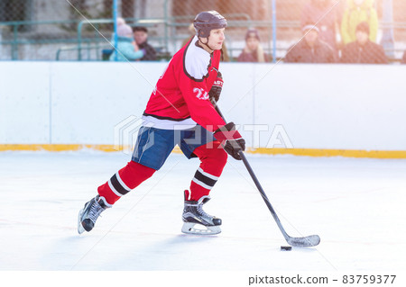 Professional ice hockey player in attack on the rink Professional ice hockey player in attack on the rink 83759377