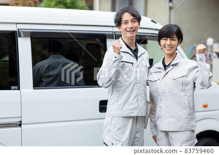 Men and women in work clothes visiting a house 83759460