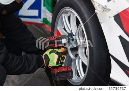 Air wrench and Tire waiting to get into action  replacement tire. 83759787