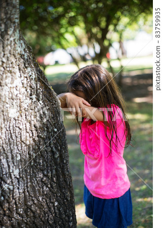 Long-haired little girl playing in park Long-haired little girl playing in park 83759935