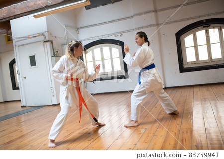 Focused young women at karate training session Focused young women at karate training session 83759941