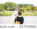 A woman looking at the Ukidono at Dazaifu Tenmangu Shrine 83759968