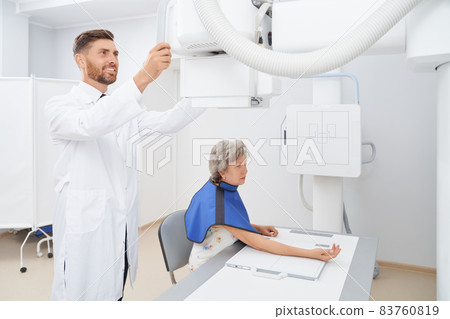 Radiologist regulating ultra sound tool preparing for diagnostic. Radiologist regulating ultra sound tool preparing for diagnostic. 83760819