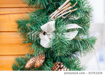 Beautiful decorations for Christmas and New Year holidays on a wooden house 83761836