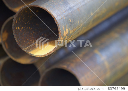 Metal profile pipe of round section in packs at the warehouse of metal products Metal profile pipe of round section in packs at the warehouse of metal products 83762499