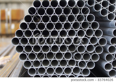 Metal profile pipe of round section in packs at the warehouse of metal products Metal profile pipe of round section in packs at the warehouse of metal products 83764026
