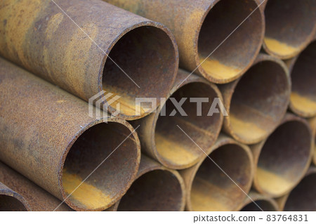 Metal profile pipe of round section in packs at the warehouse of metal products Metal profile pipe of round section in packs at the warehouse of metal products 83764831