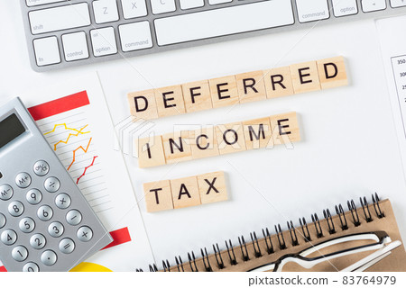 Deferred income tax concept with letters on cubes 83764979