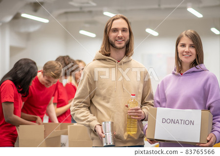 Volunteers working in a donations distribution center Volunteers working in a donations distribution center 83765566