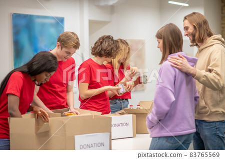 Volunteers working in a donations distribution center Volunteers working in a donations distribution center 83765569