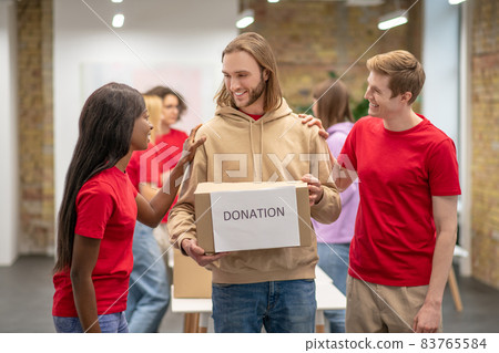 Workers of the non profit organization distributing donations Workers of the non profit organization distributing donations 83765584