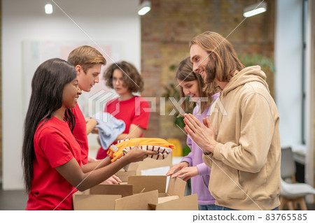Workers of the non profit organization distributing donations Workers of the non profit organization distributing donations 83765585