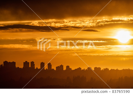 Cityscape on sunset cloudy sky background closer to the night 83765590