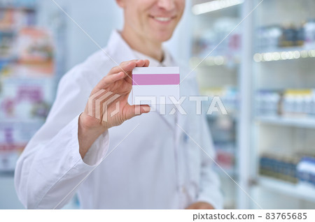 Male hand showing packaging of medicinal product Male hand showing packaging of medicinal product 83765685