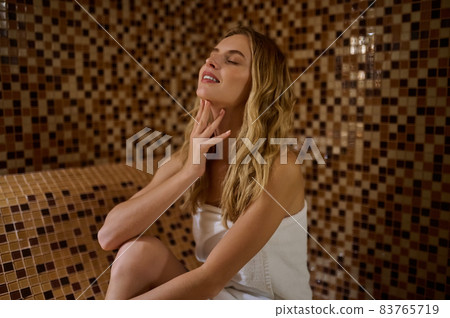 A blonde cute young woman in a hammam looking relaxed A blonde cute young woman in a hammam looking relaxed 83765719