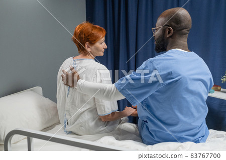 Doctor talking to patient in the ward Doctor talking to patient in the ward 83767700