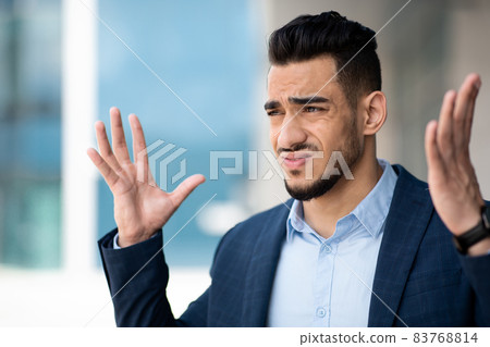 Furious middle eastern businessman gesturing, copy space 83768814