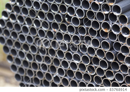 Metal profile pipe of round section in packs at the warehouse of metal products Metal profile pipe of round section in packs at the warehouse of metal products 83768914