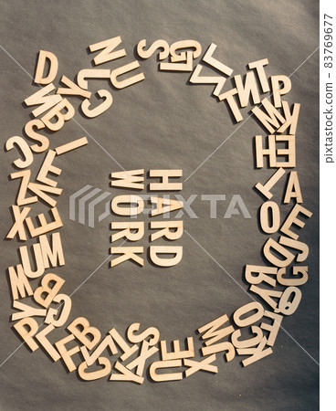Word Hard Work In Wooden Cube Alphabet Letters Top View On A rustic paper Background. 83769677